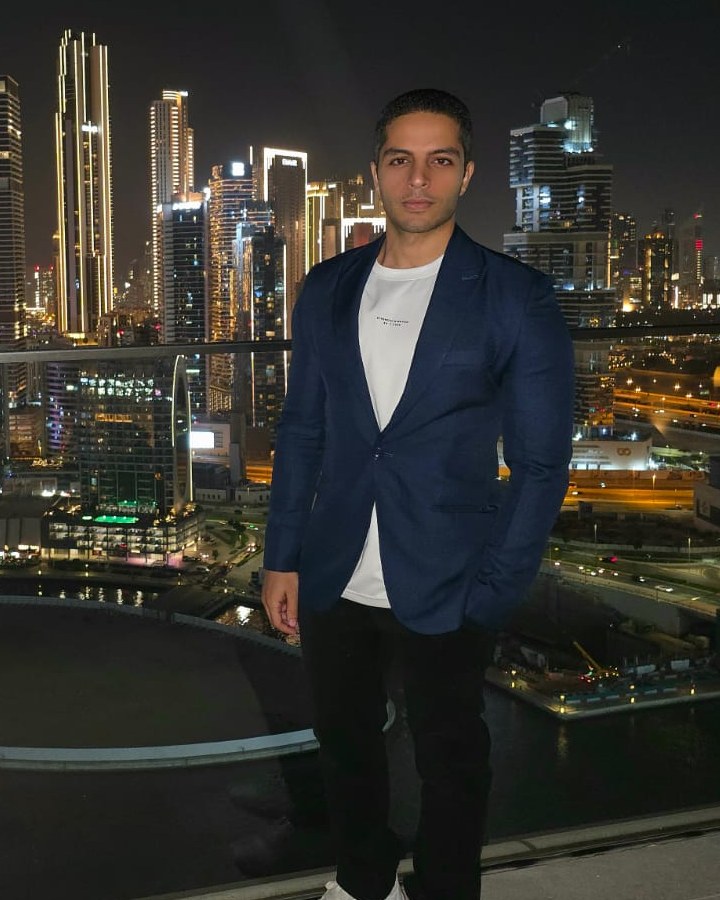 Seif Samir, founder of Flickwrite, Hiriy and Ignite AI System, on a rooftop over the Dubai skyline at night